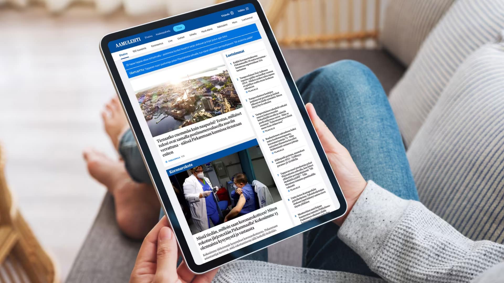 A person reading news on a tablet, illustrating the benefits of News Article APIs for Startups and Small Businesses