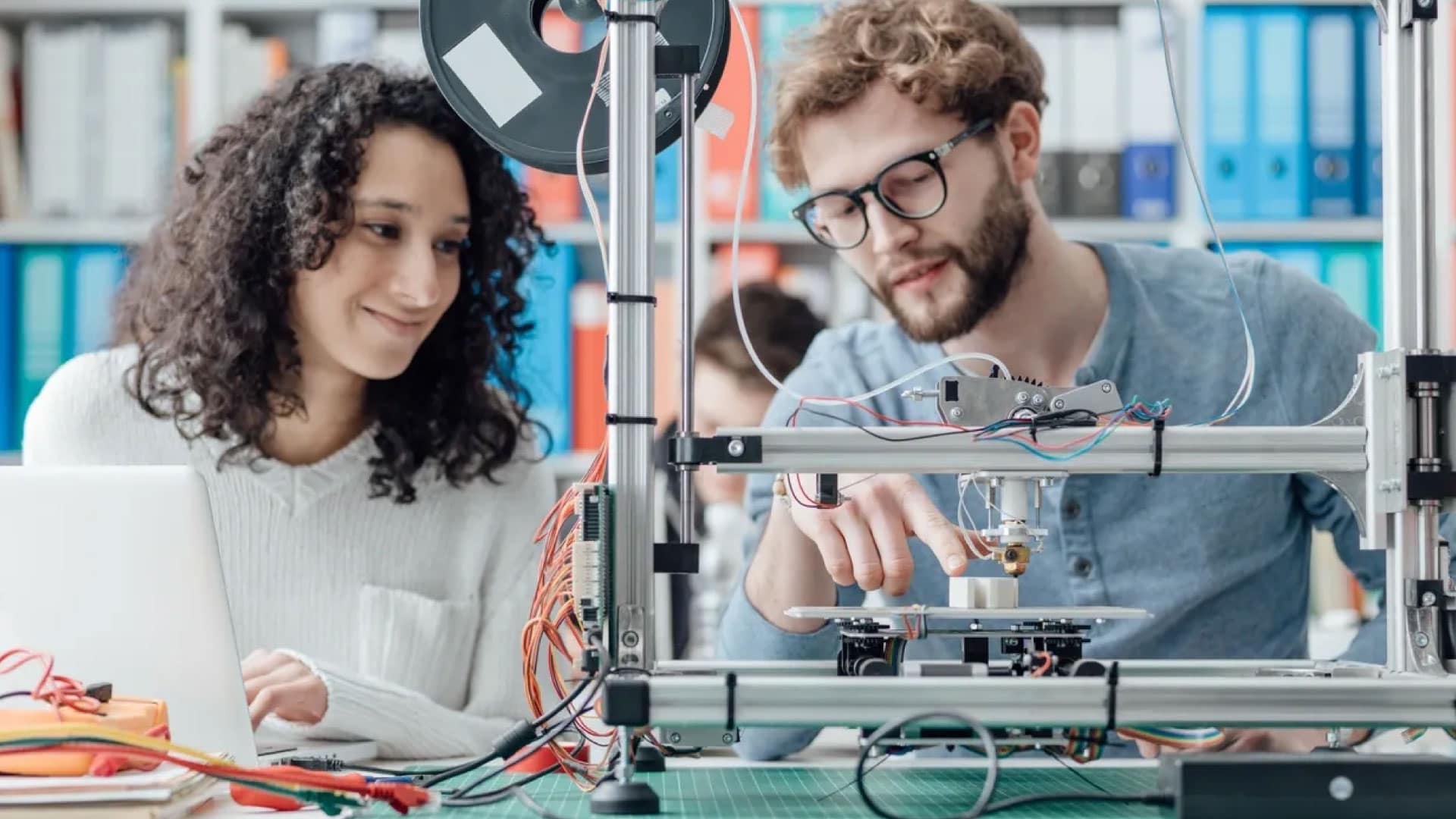 Two people working on creating a prototype, showcasing the benefits of Rapid Prototype Injection Molding in accelerating product development