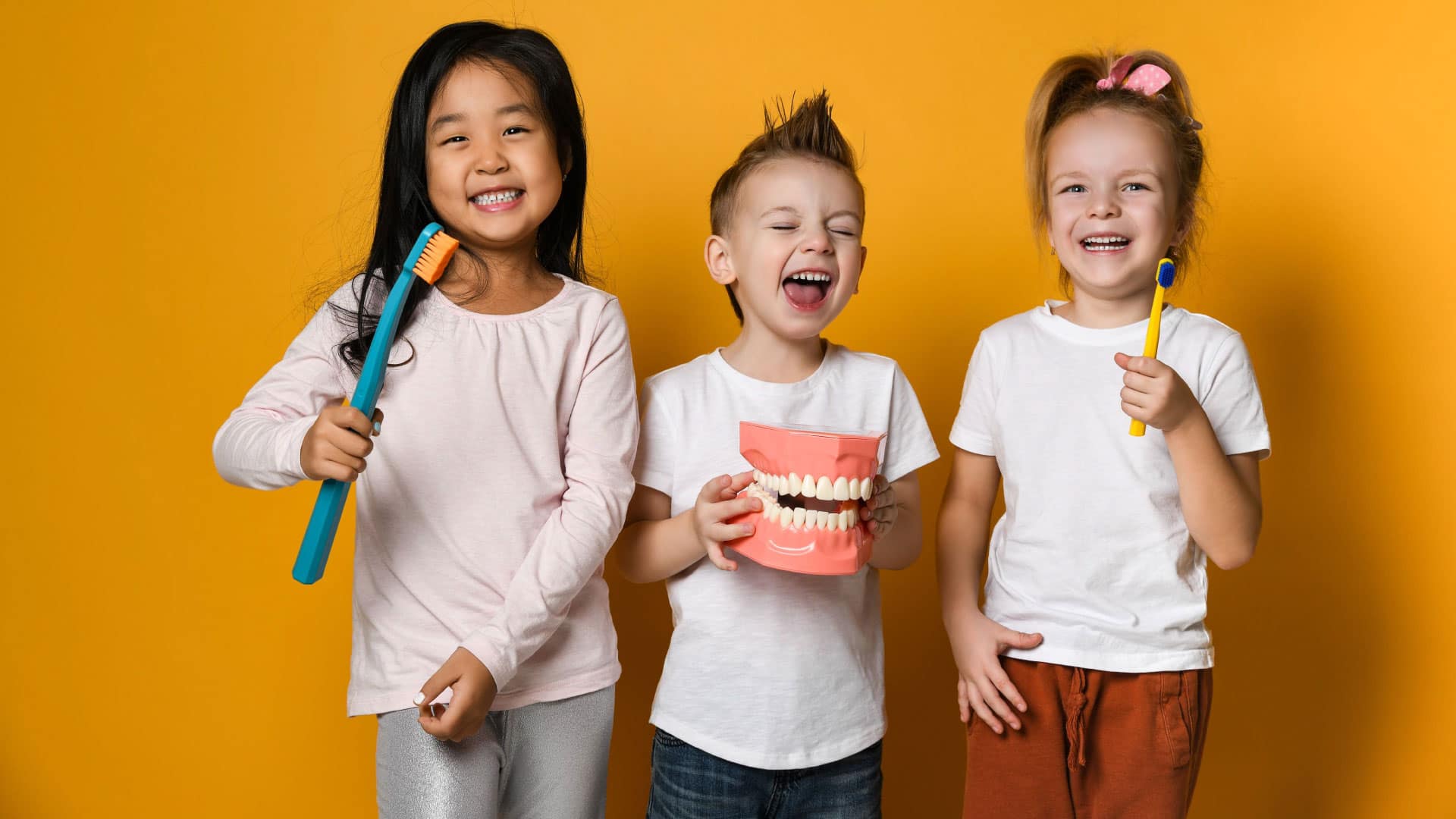 Children brushing teeth, highlighting the need for establishing a pediatric orthodontic practice in rural areas to ensure proper dental care.