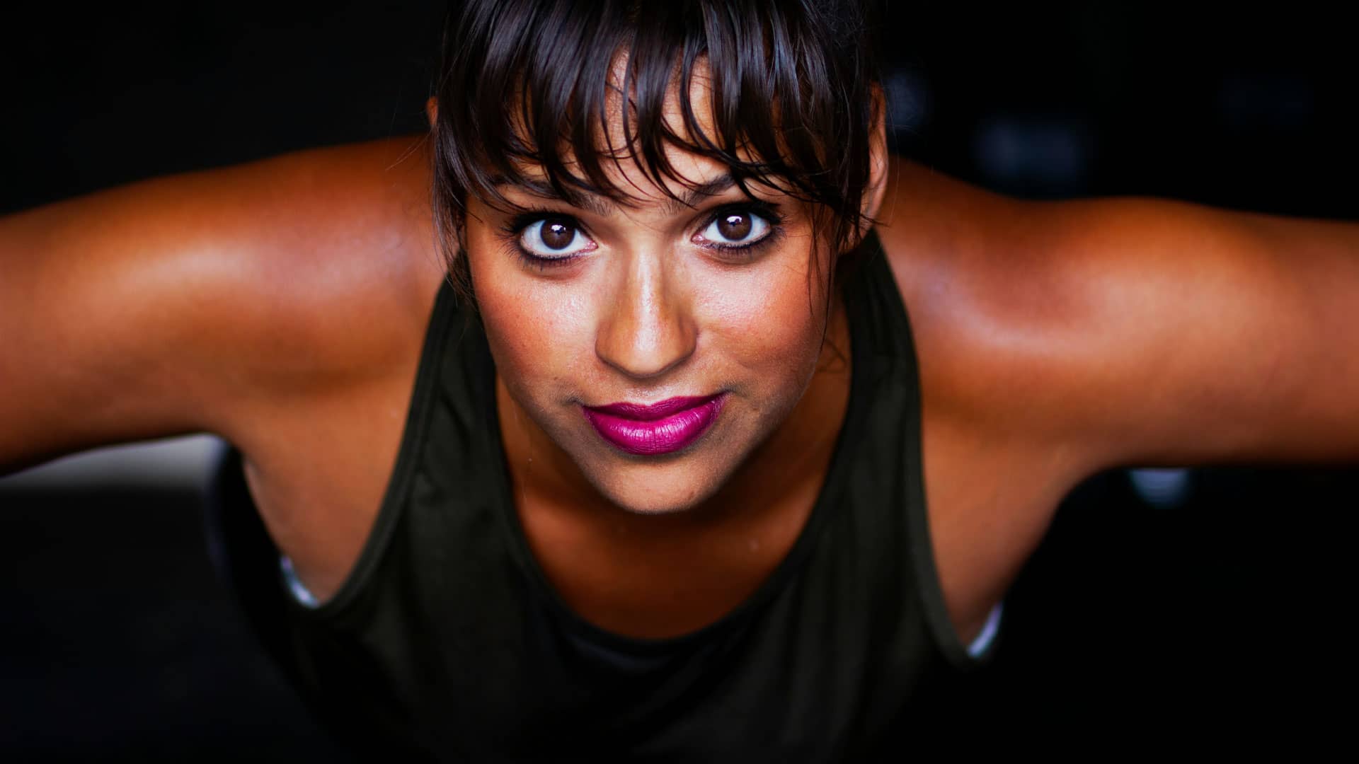 A determined woman doing push-ups, demonstrating strength and resilience.