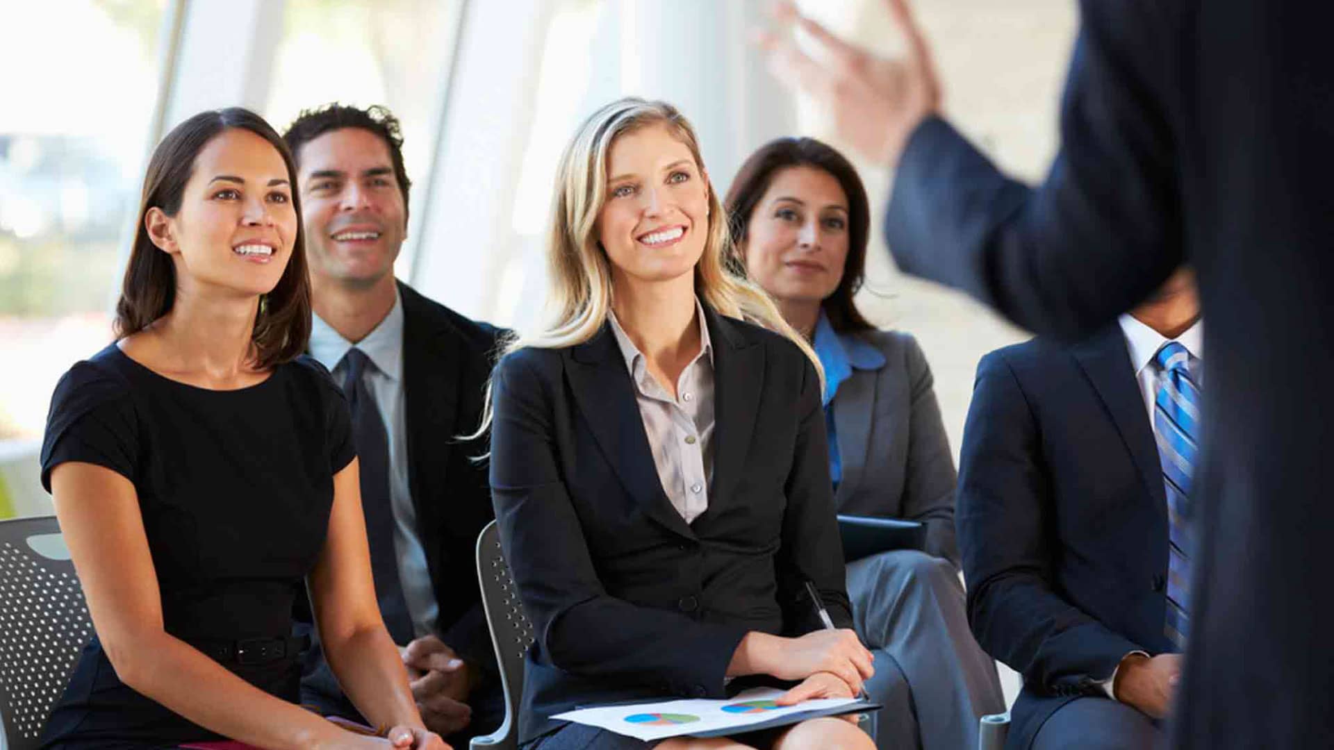 Boost Contact Center Performance - people engaged in a training session, showcasing agent training programs.